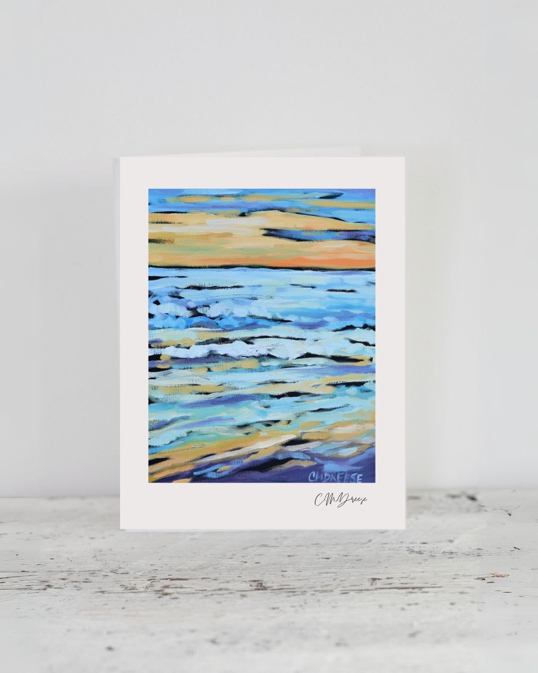 Notecard titled 'When the Sun Goes Down' displayed beside white linen envelope and clear protective cellophane bag.