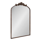 Traditional rectangular wall mirror with an arched top and ornate dark brown carved wood crest featuring scroll and leaf motifs.