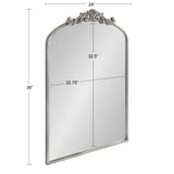 Tall rectangular mirror with an arched top and intricate silver ornamental detailing on the arch, showing height 36 inches and width 24 inches.