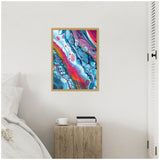 Abstract framed canvas with swirling patterns of blue, red, pink, and white, hanging above a rustic wooden nightstand in a minimalist bedroom corner.