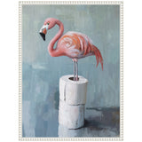 Pink flamingo standing with one leg raised on a stack of three white toilet paper rolls against a muted blue-grey background, framed in white ornate molding.