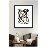 Abstract black curved and twisted lines on a beige background framed in black, hanging above an olive green armchair and wooden round table with white ceramic decor.