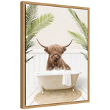 Framed canvas art of a highland cow sitting in a palm leaf-patterned bathtub, by Amy Peterson