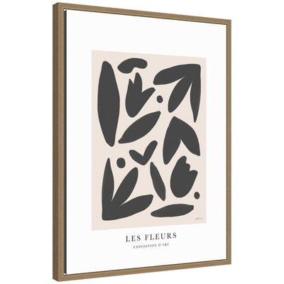 Exposition d Art Les Fleurs framed canvas wall art print styled on a white wall above vintage chair with a woven seat