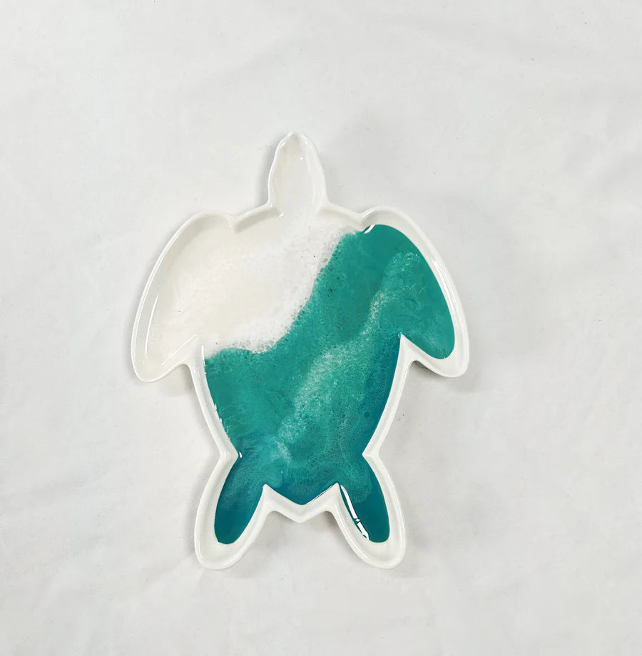 Teal and white turtle-shaped resin ceramic tray on a light gray background