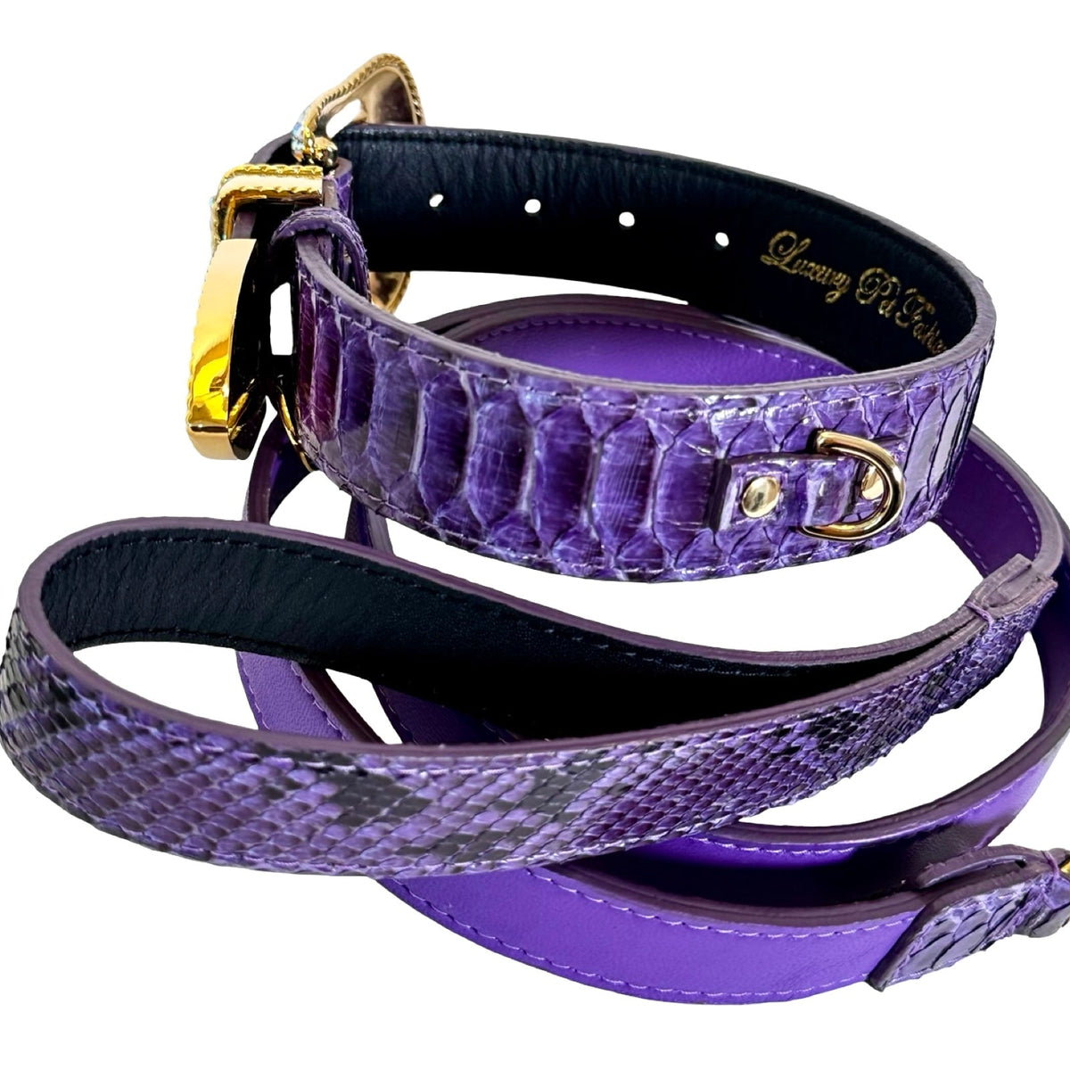 Close-up of a purple python leather strap and matching leash with gold-tone metal hardware, showing textured scales and stitched black inner lining.