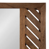 Close-up of a wooden wall mirror frame with a geometric diagonal slat pattern on the right side and smooth wood on the top edge, showing warm brown tones.