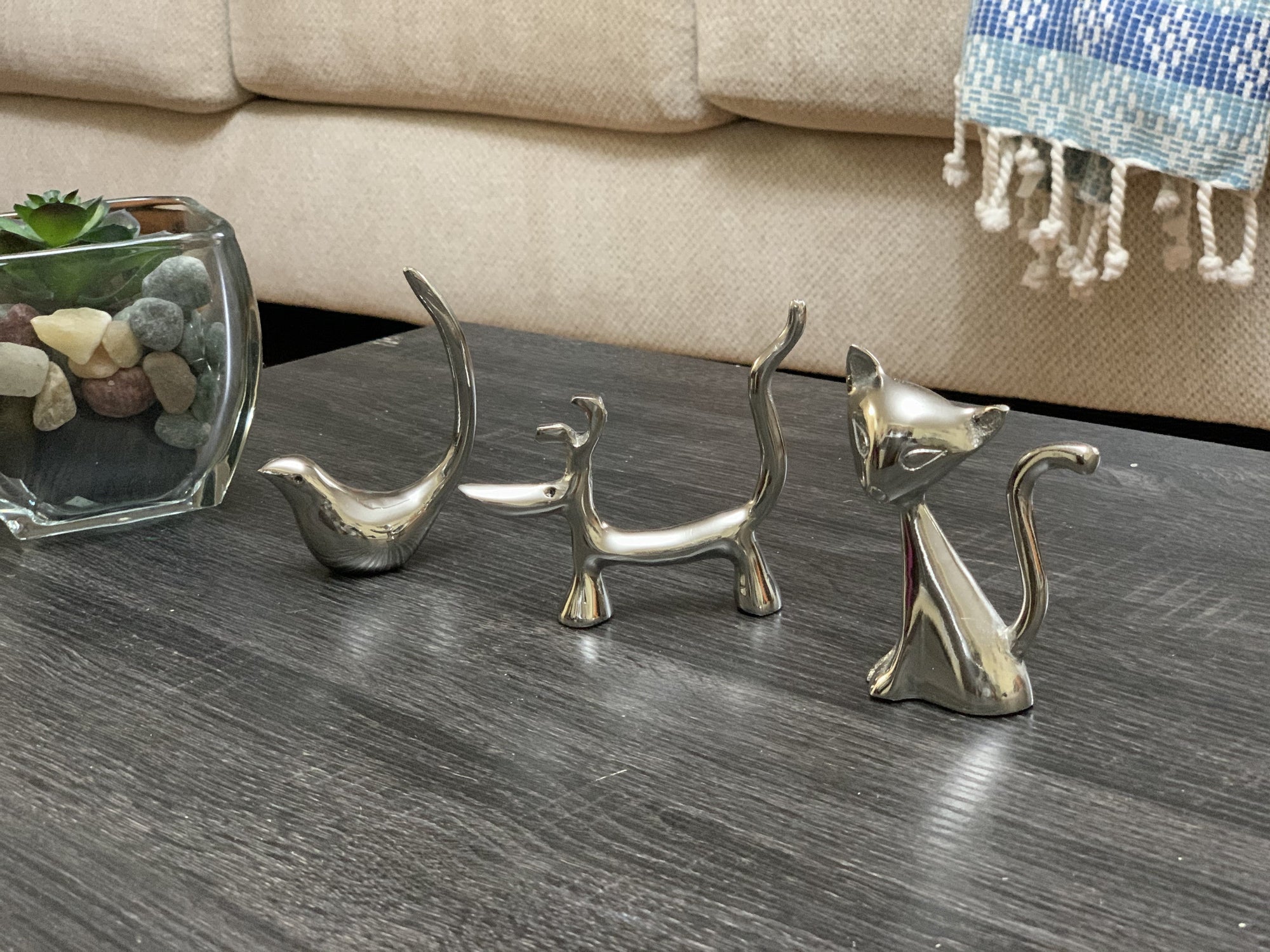 Vibhsa silver dog, cat, and bird ring holder figurines arranged together on a tabletop