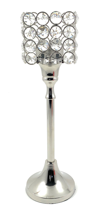 Square crystal candle holder with faceted surfaces reflecting light