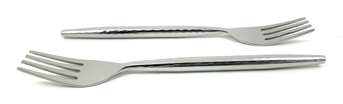 Six Vibhsa salad appetizer forks with hammered textured handles laid out on white cloth
