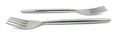 Six Vibhsa salad appetizer forks with hammered textured handles laid out on white cloth