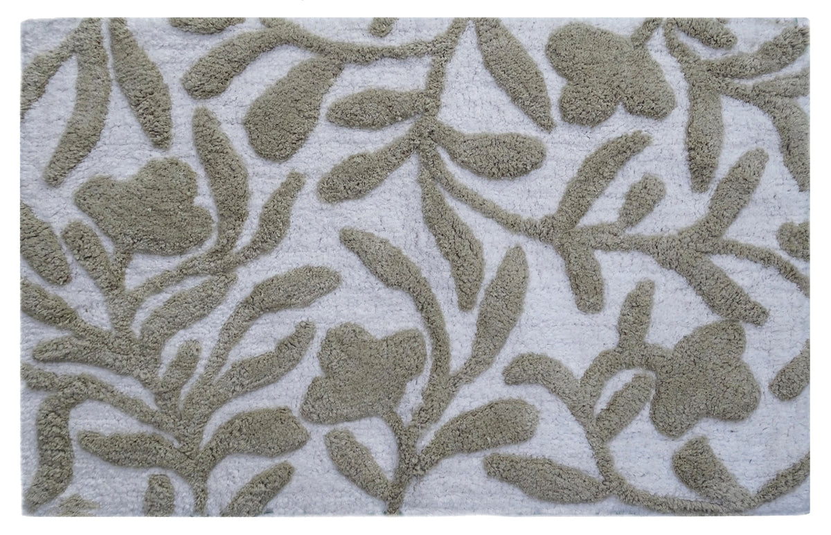 Beige and ivory damask patterned CHICOS HOME bath rug laid on floor