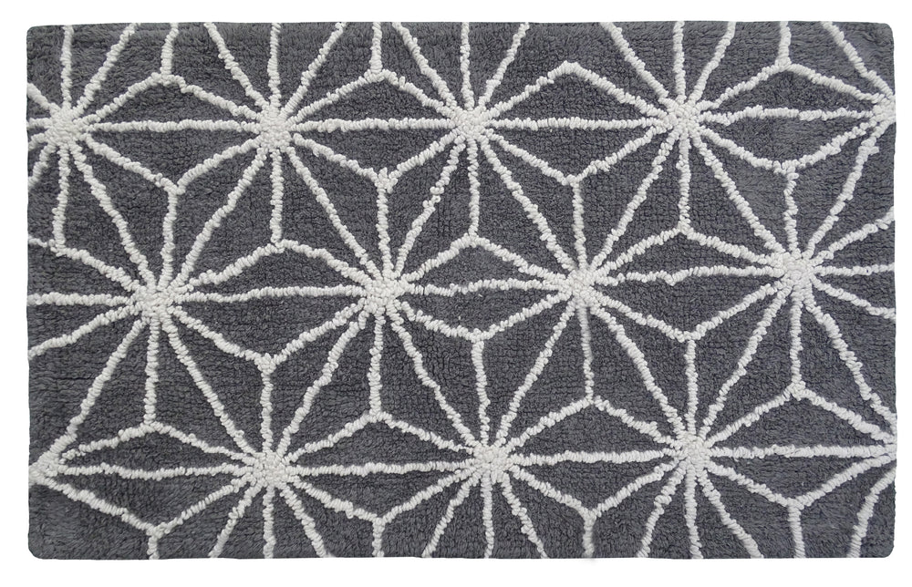 CHICOS HOME bath rug with geometric pattern in grey and ivory on bathroom floor