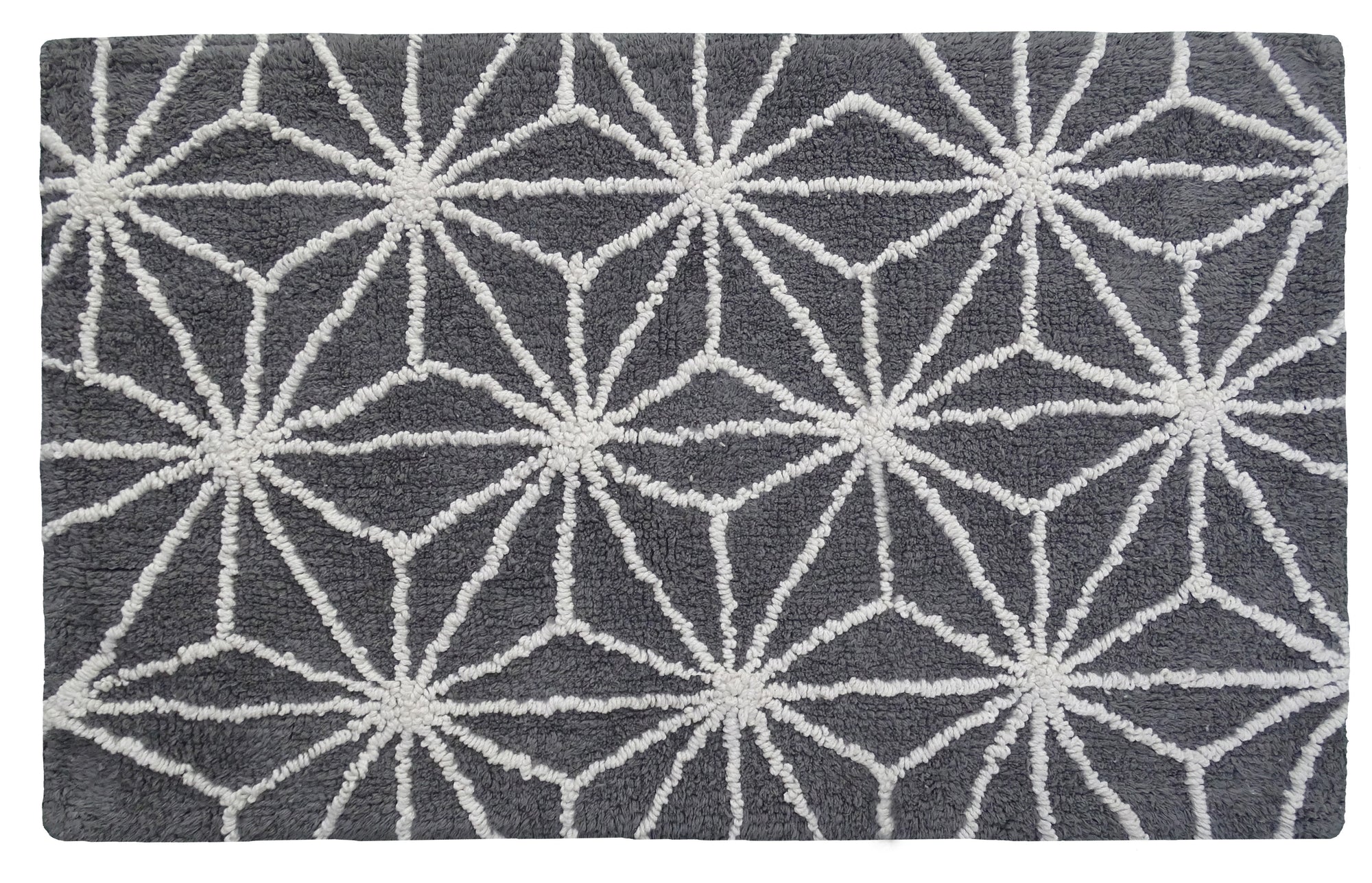 CHICOS HOME bath rug with geometric pattern in grey and ivory on bathroom floor