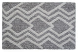 CHICOS HOME Bath Rug with geometric pattern in grey and ivory laid on a floor
