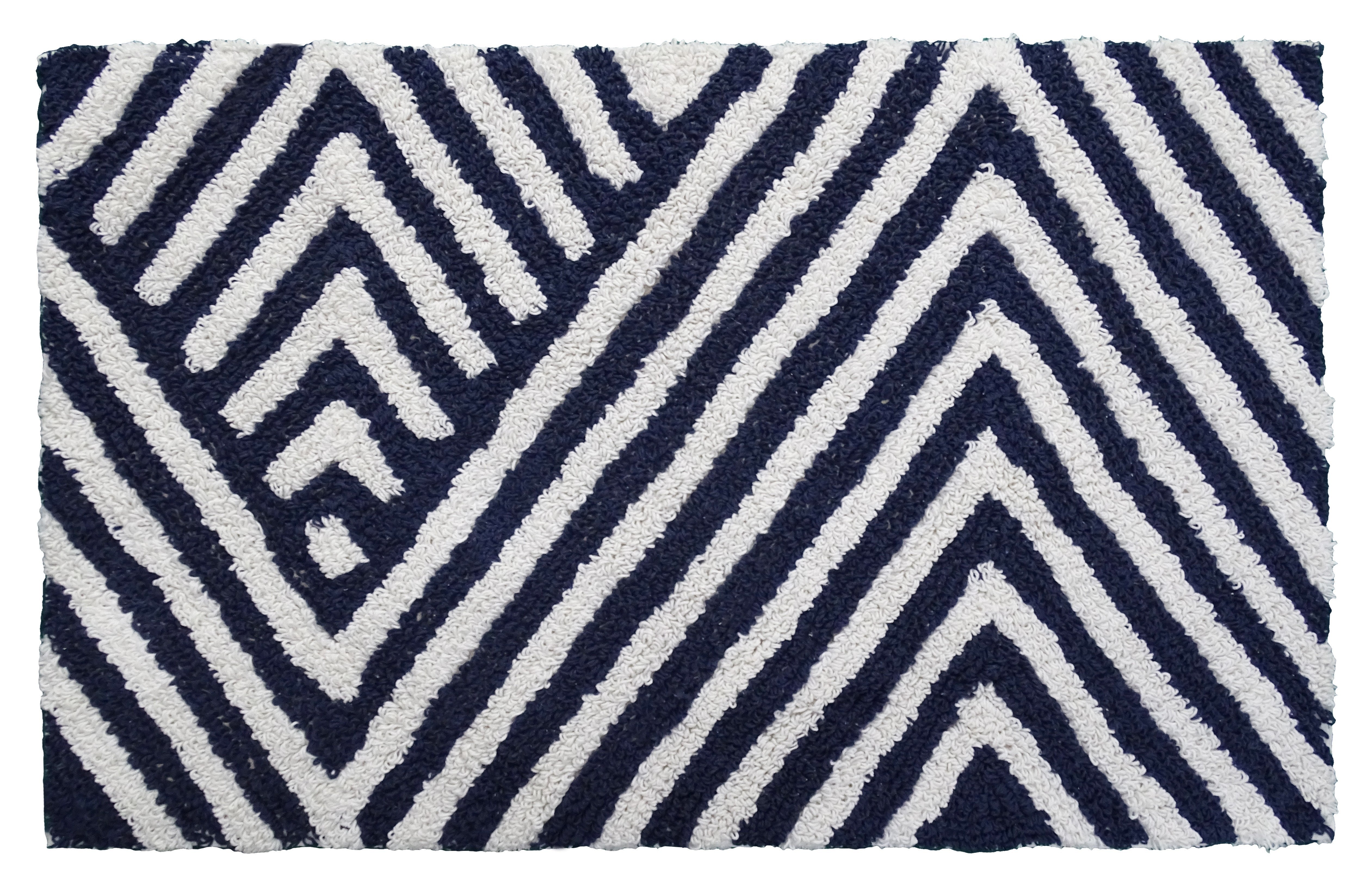 Bath rug with charcoal and ivory chevron pattern laid on bathroom floor near tub