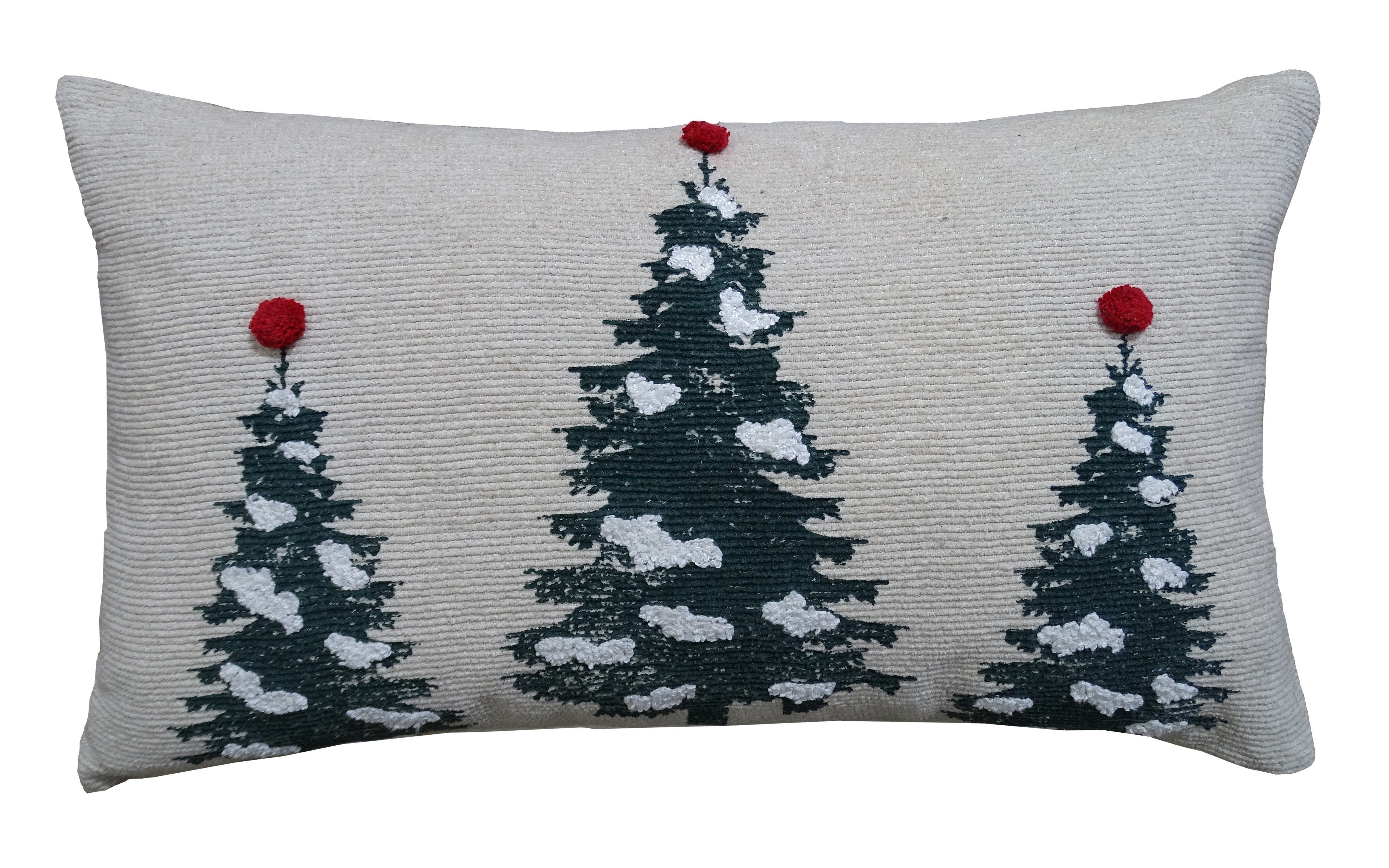 Christmas Throw Pillow with embroidered Christmas trees and pom pom detail on a couch