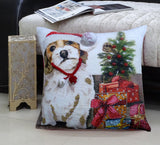 Square pillow with printed design of a dog wearing a red Santa hat and collar, next to a small decorated Christmas tree and colorful wrapped gifts.