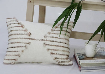Pink embroidered throw pillow with light pink embroidery on front and solid color back