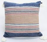 22 by 22 inch throw pillow with striped chenille texture and tassels on corners on a couch