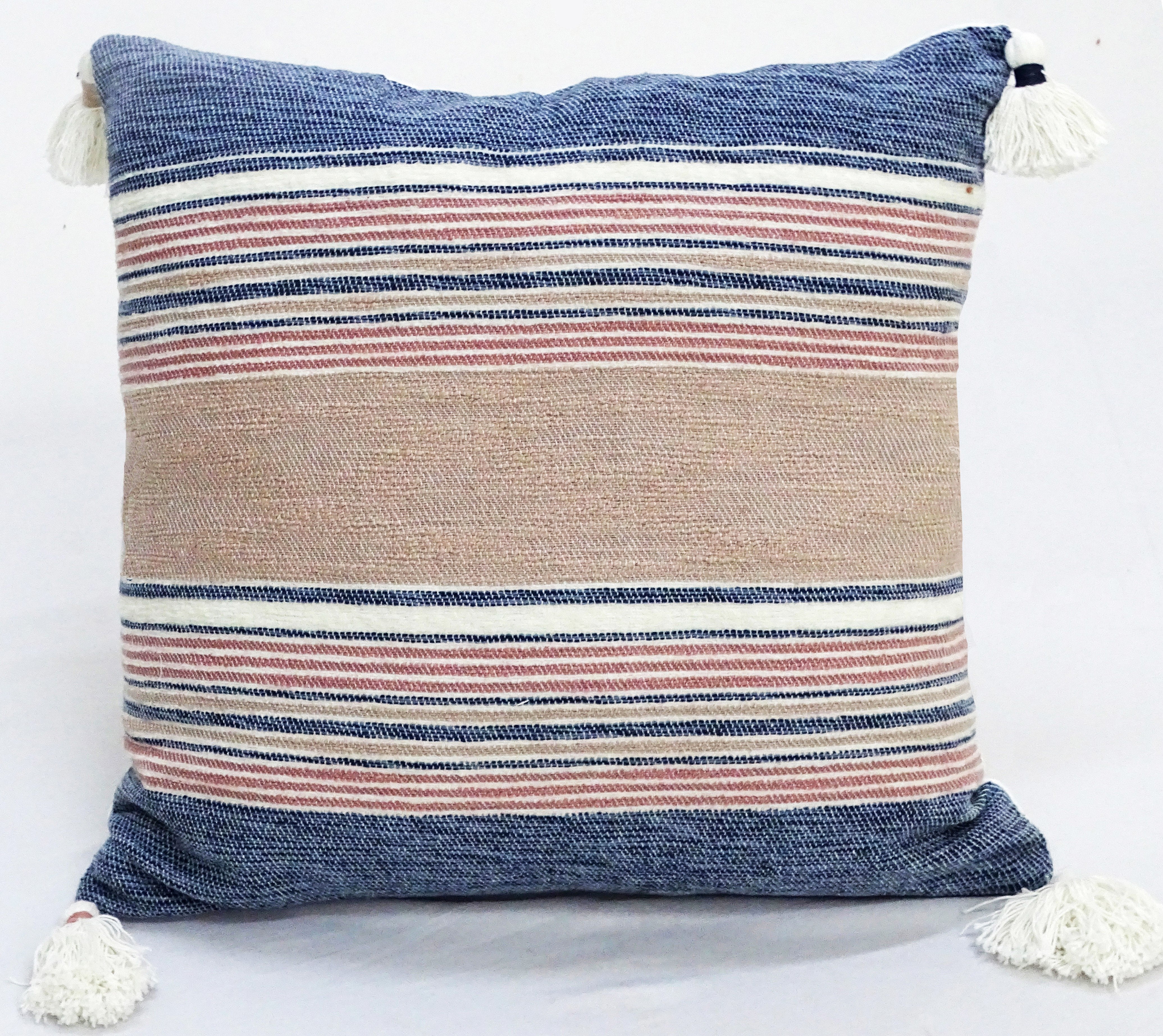 22 by 22 inch throw pillow with striped chenille texture and tassels on corners on a couch