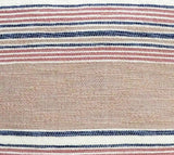 Close-up of a throw pillow fabric showing textured beige center with horizontal navy blue, red, and white stripes above and below.