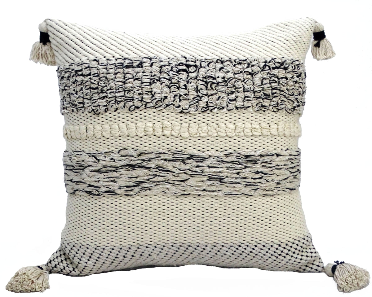 Square throw pillow with cream base and black woven textured stripes, featuring tassels on all four corners, shown front-facing on white background.