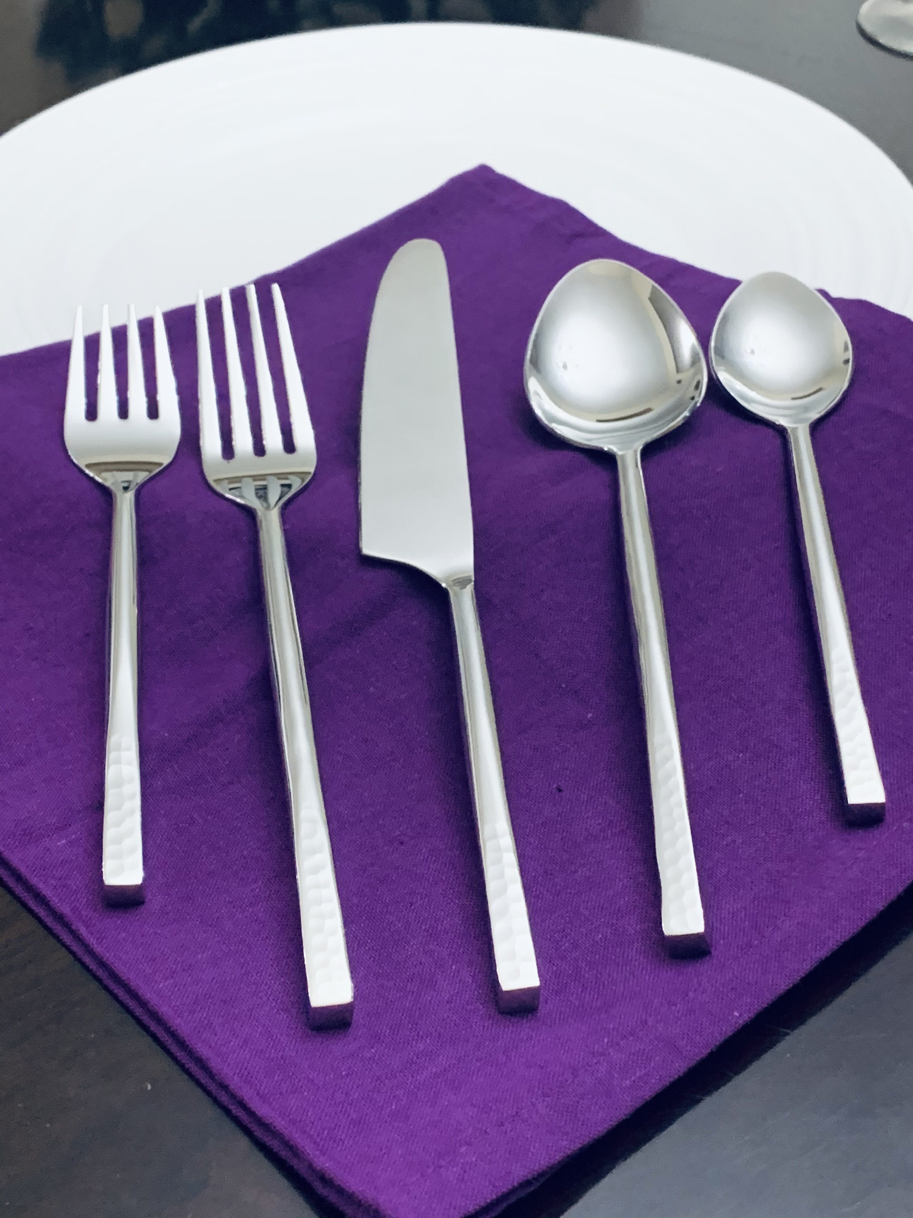 Vibhsa 20 Piece Flatware Set laid out on a table with silver glossy finish