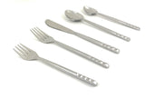 Vibhsa 20 Piece Flatware Set with silver glossy finish displayed on beige fabric