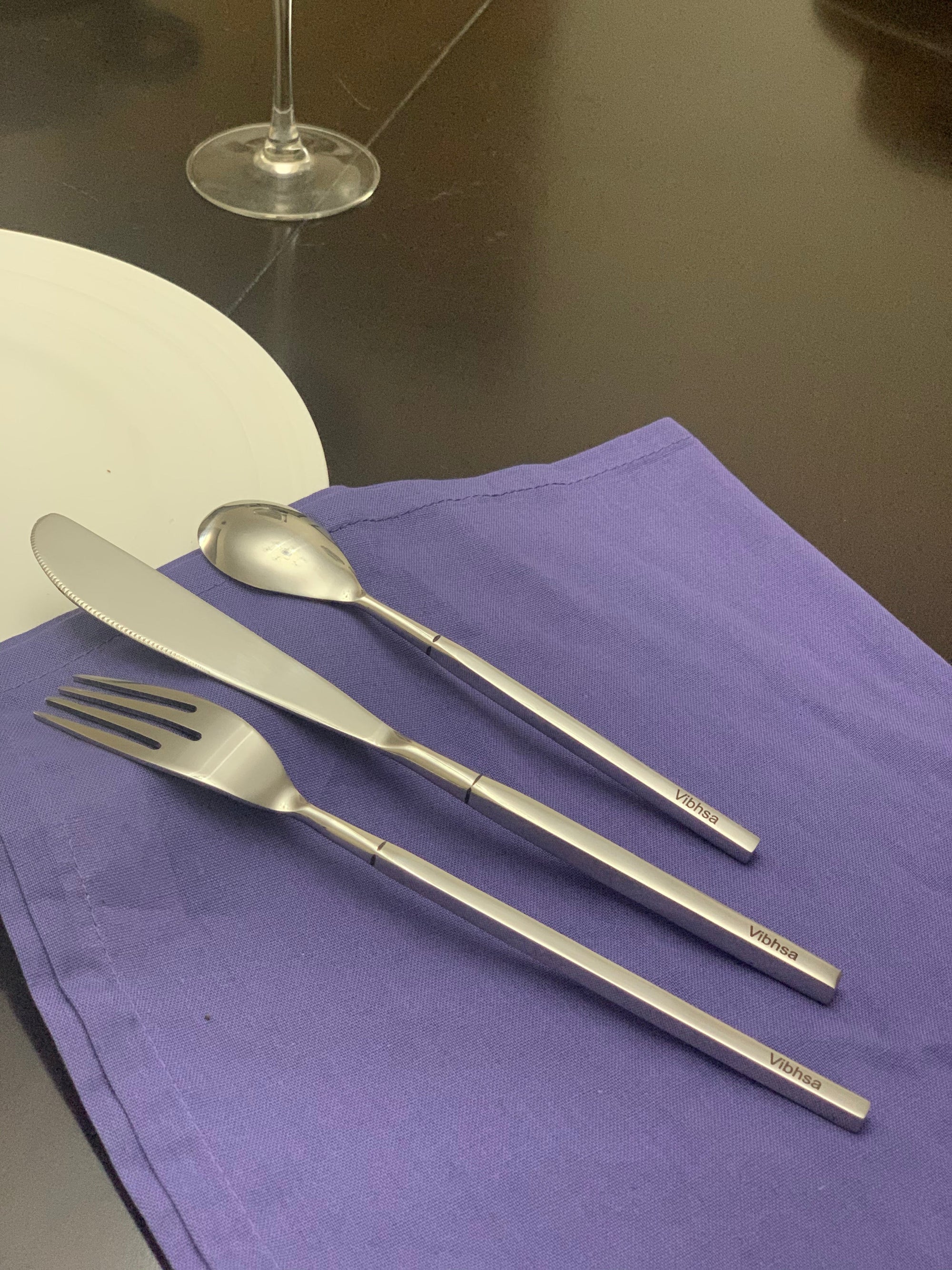 Vibhsa 36-piece stainless steel flatware set arranged on a table