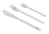 Three-piece stainless steel flatware set with a serrated dinner knife, a four-tine dinner fork, and a rounded dessert spoon, all with straight handles and a subtle band near the neck.