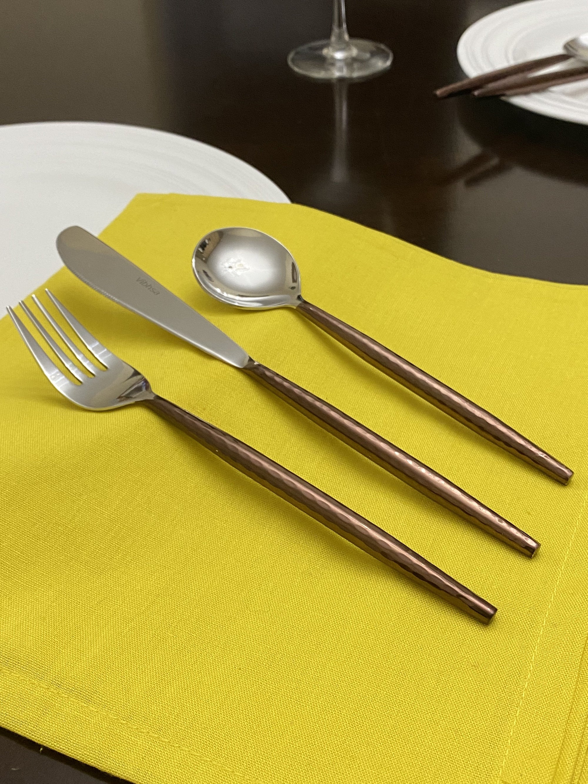 Hammered Stainless Steel Flatware 36-Piece Set by Vibhsa showing knives, spoons, and forks with hammered handle design and high gloss finish.