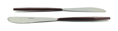 Set of six stainless steel dinner knives by Vibhsa arranged on a cloth napkin