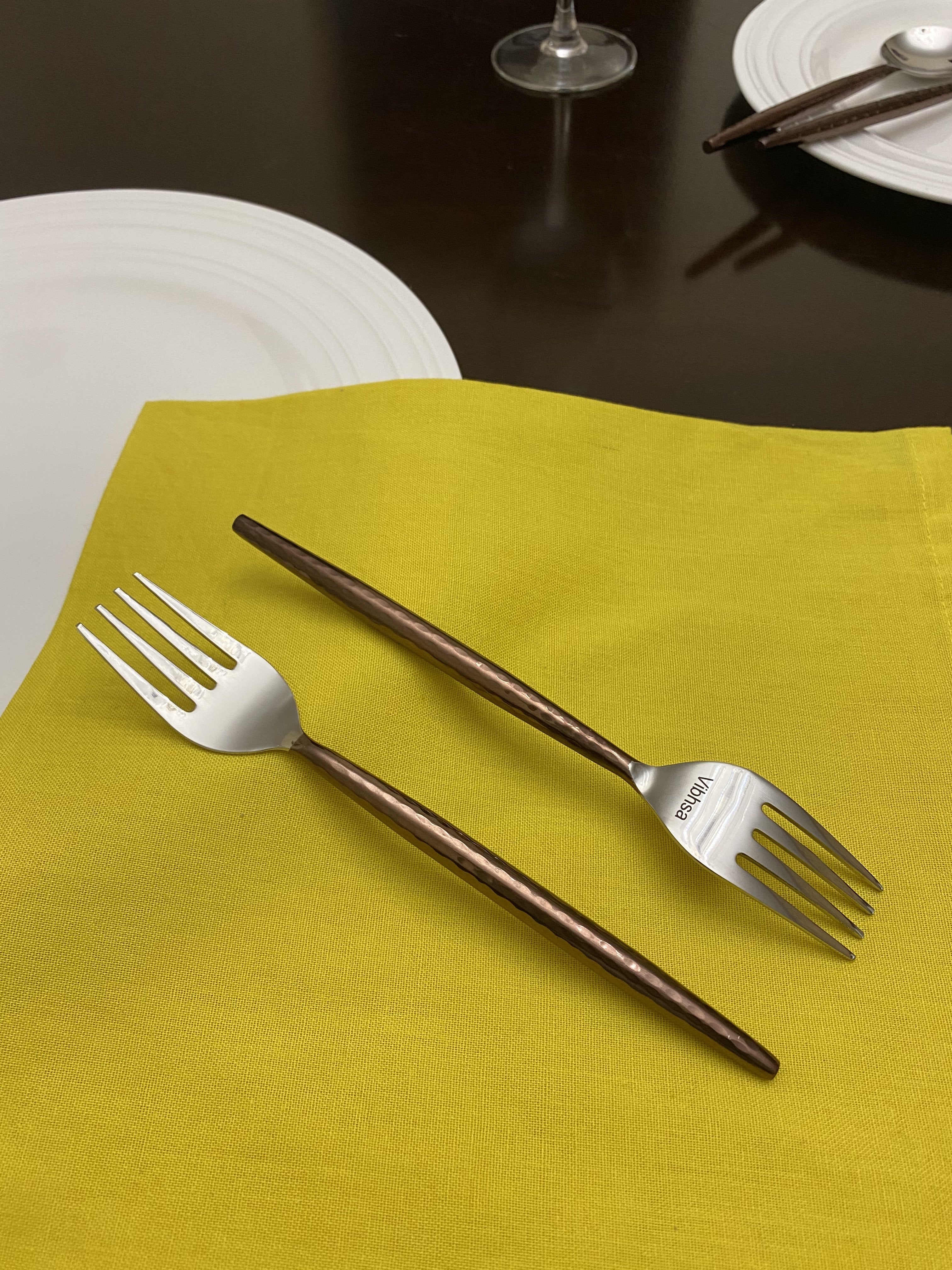 Set of 6 brown-handled stainless steel salad appetizer forks arranged on wood surface