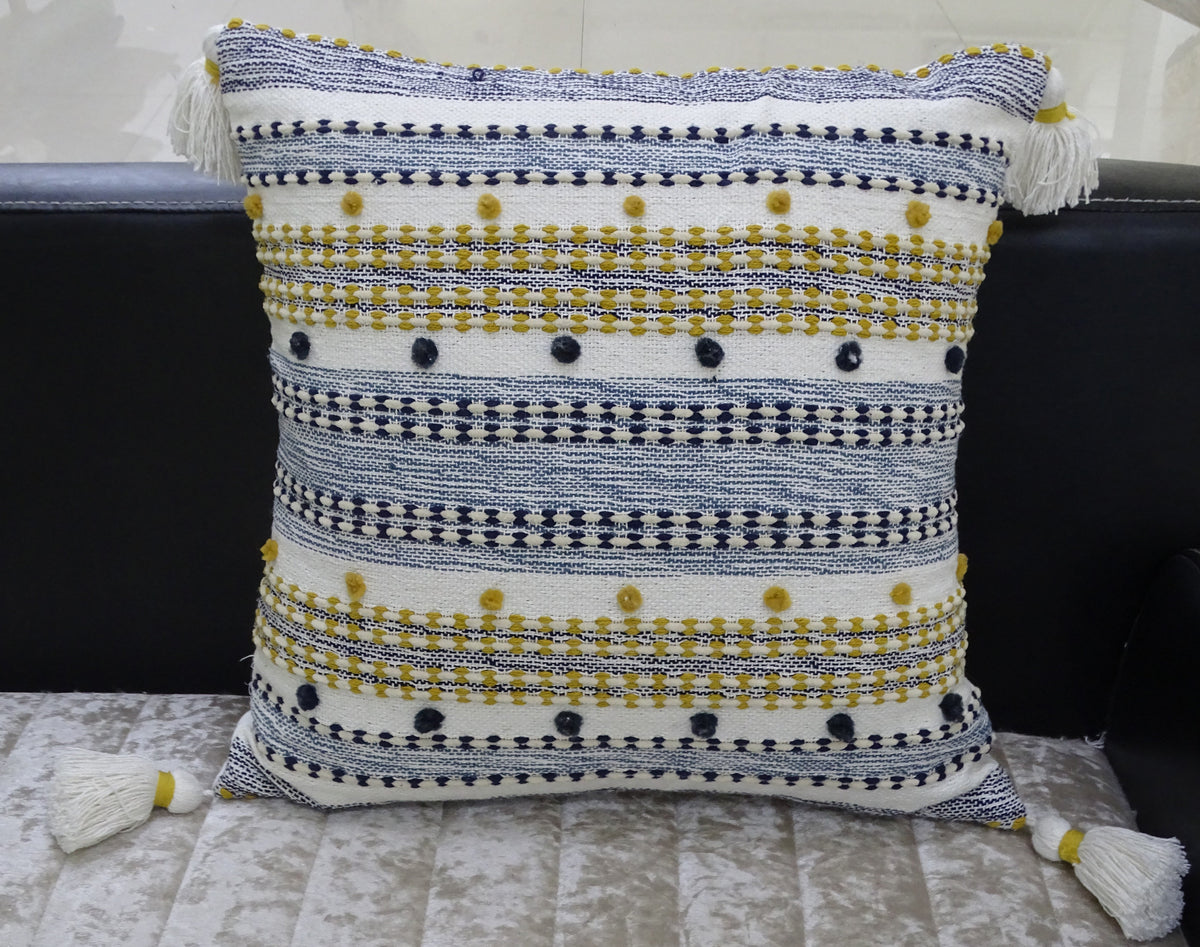 Designer Striped Pillow with mini pom-poms and tassels displayed on dark chair