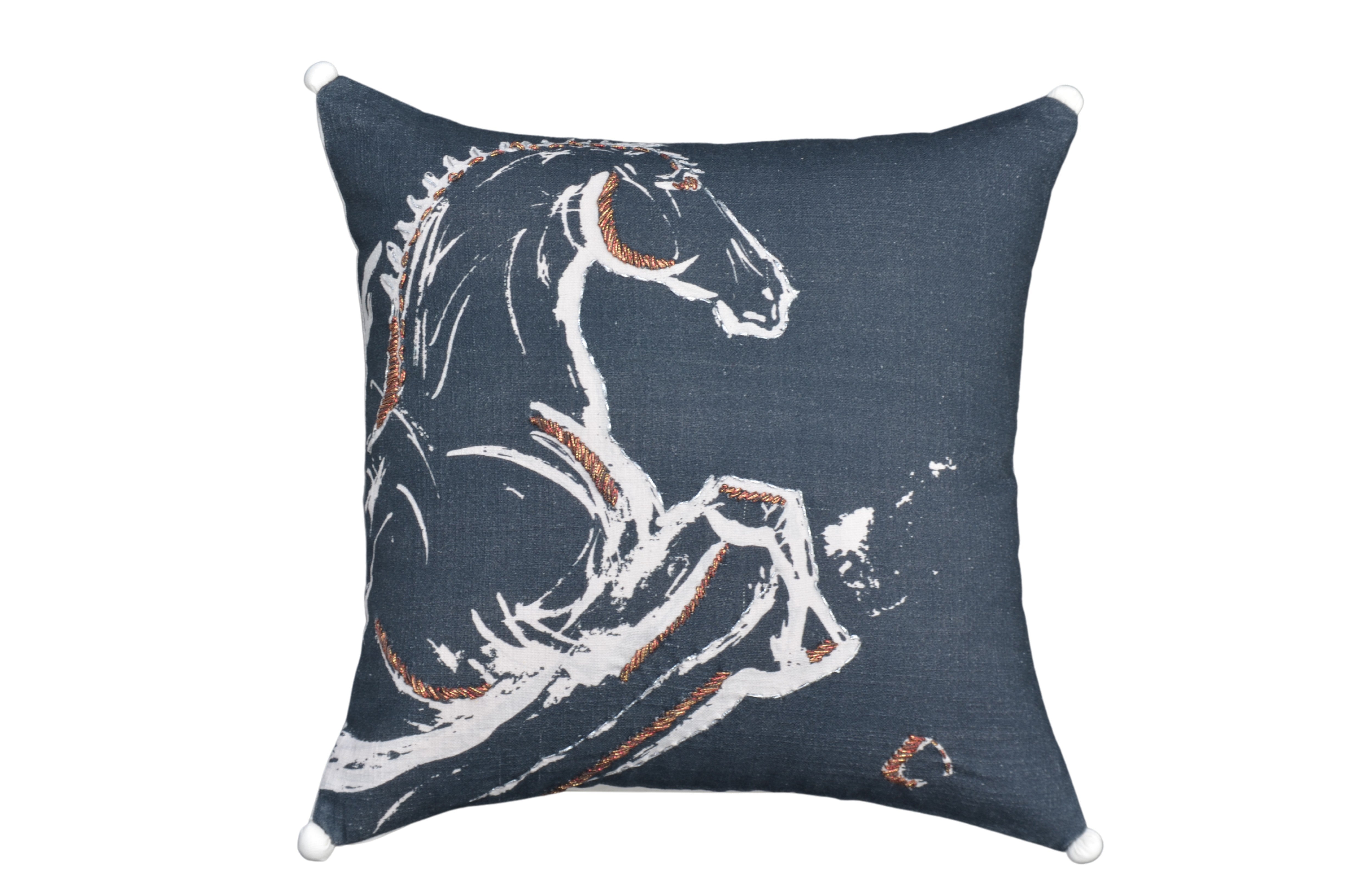 Black embroidered decorative pillow with colorful pom-poms and tassels on a sofa