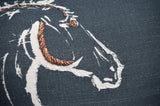 Close-up of black fabric pillow embroidered with a white outline of a horse's head, featuring copper metallic thread accents on the mane and ear.