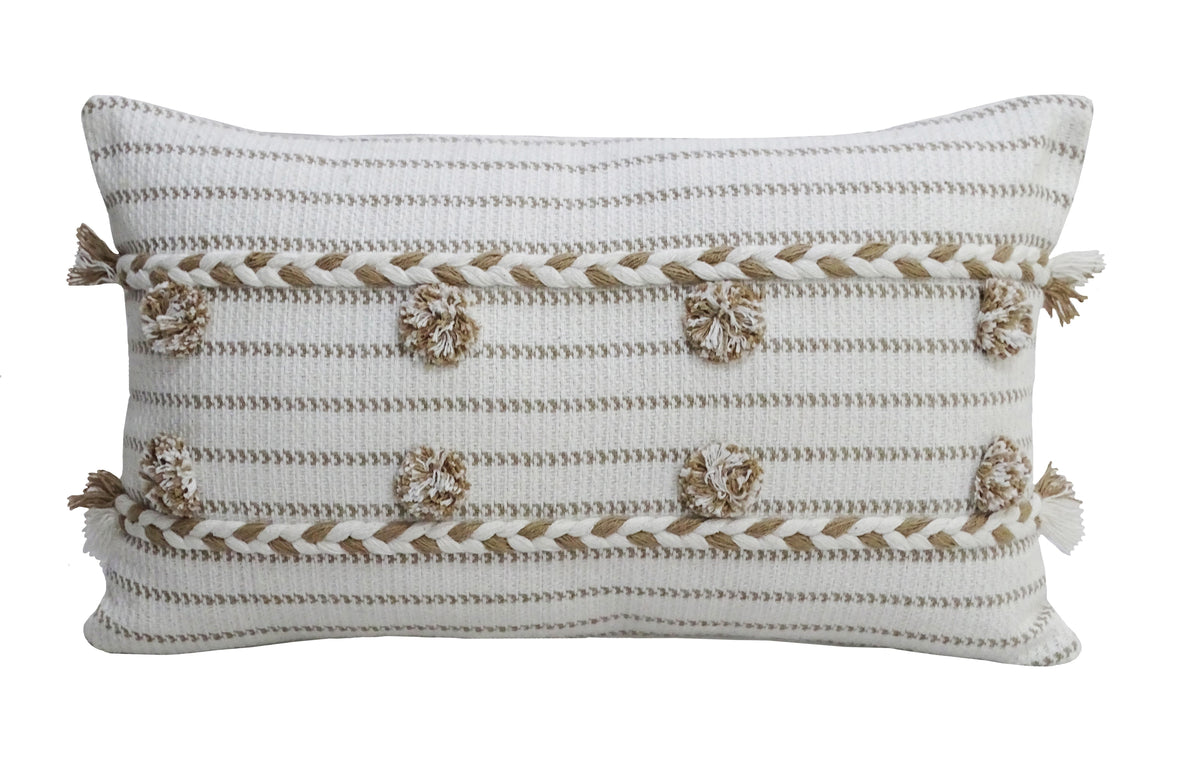 Rectangular off-white throw pillow with horizontal beige stripes, decorated with evenly spaced beige poms and tassels along edges on a white background.