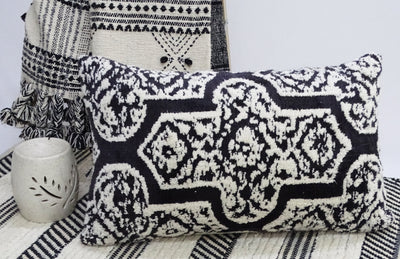 Handwoven 14x24 inch colorful throw pillow with solid back on sofa