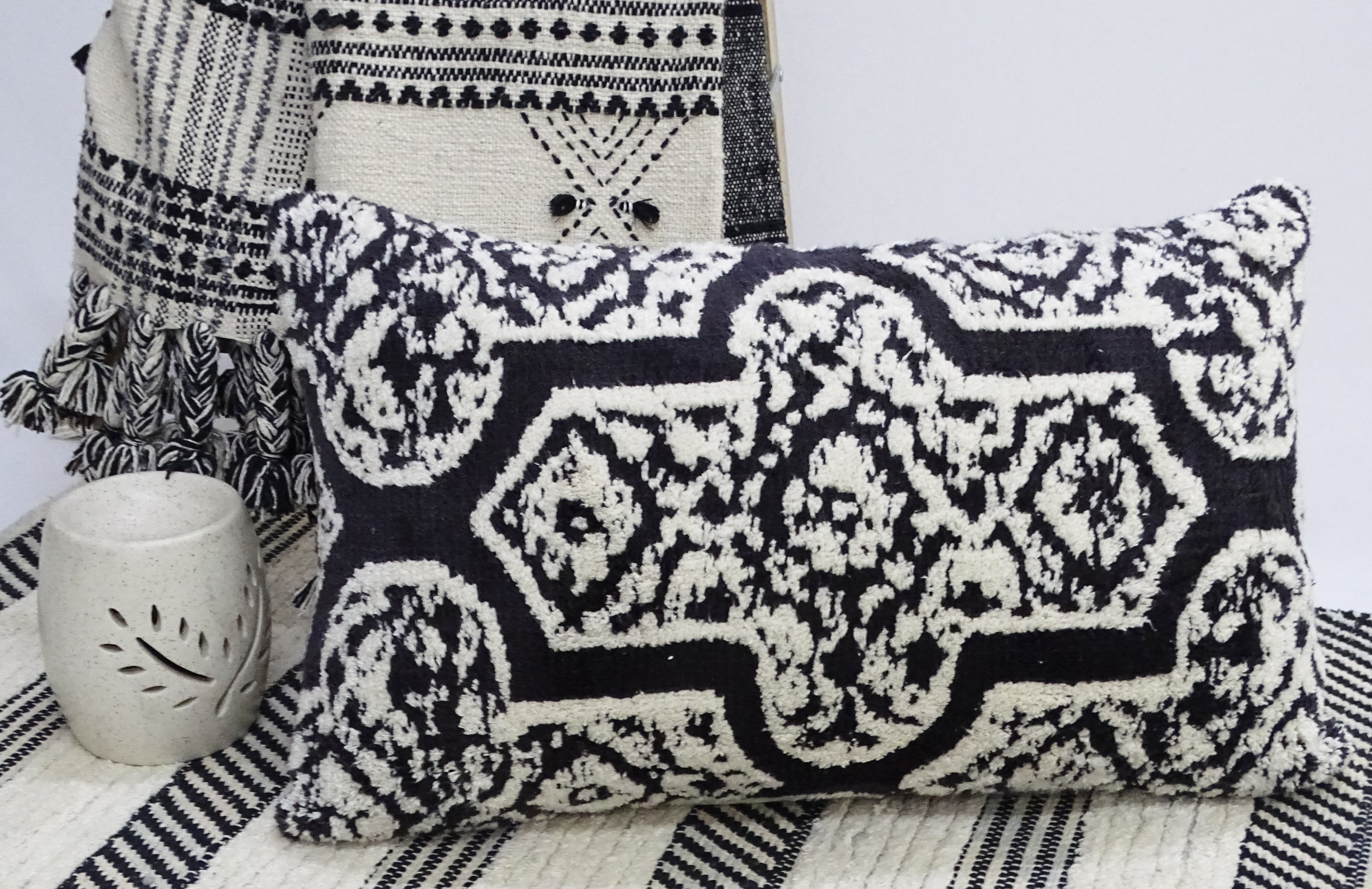 Handwoven 14x24 inch colorful throw pillow with solid back on sofa