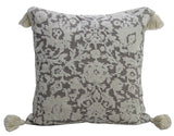 Square cream throw pillow featuring a brown damask pattern and cream-colored tassels on each corner