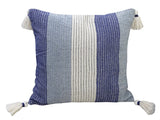 Square handwoven throw pillow with vertical stripes in shades of blue and white, featuring white tassels on each corner.