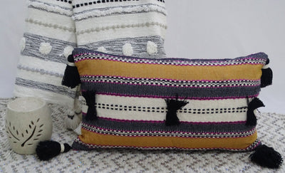 Handwoven 14x24 throw pillow with colorful front and corner tassels