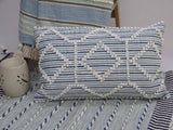Modern handwoven colorful throw pillow 14x24 inches on a sofa