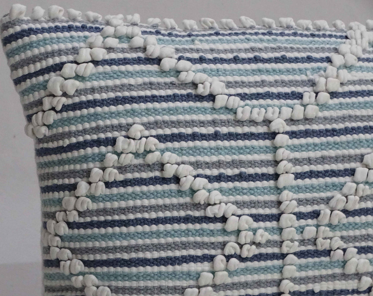 Handwoven 14x24 inch throw pillow with horizontal blue, teal, and white stripes and white textured geometric patterns.