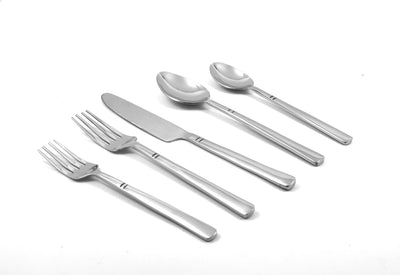 Modern flatware set of 20 pieces silver stainless steel with sleek modern handles and shiny silver ends, arranged on a wooden surface.