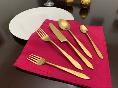 Flatware set of 20 pieces featuring golden stainless steel utensils arranged neatly