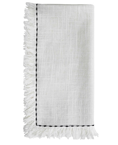 Set of four white cotton napkins with black embroidery placed on a wooden table as dining decor