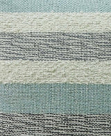 Close-up of textured woven fabric featuring alternating horizontal stripes in muted blue, creamy white, and gray tones with visible fiber detail.