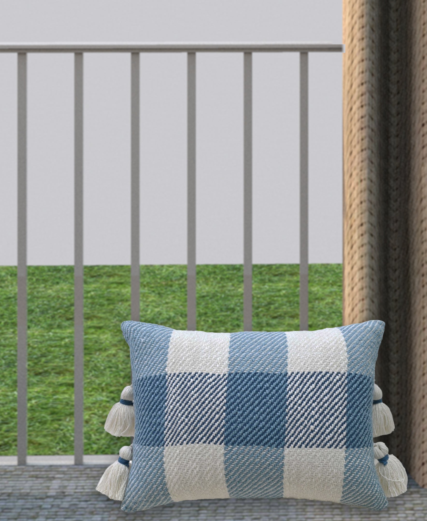 Handloom woven textured plaid decorative pillow with tassels on a woven chair seat